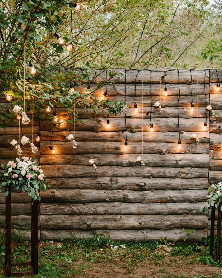 Wooden wall decorated garland with luminous bulbs and electric lamps decorated flowers. Original wedding floral decoration.  Wedding. Reception. Lounge zone. SOBOLEVSKYI.COM